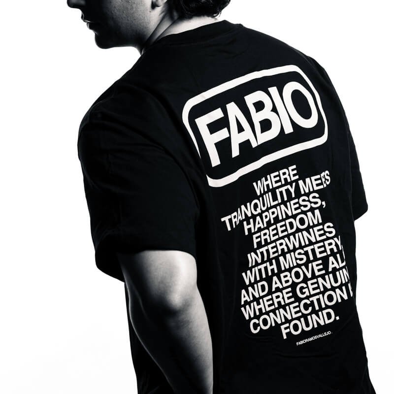 Back of a black T-shirt featuring a large typographic design